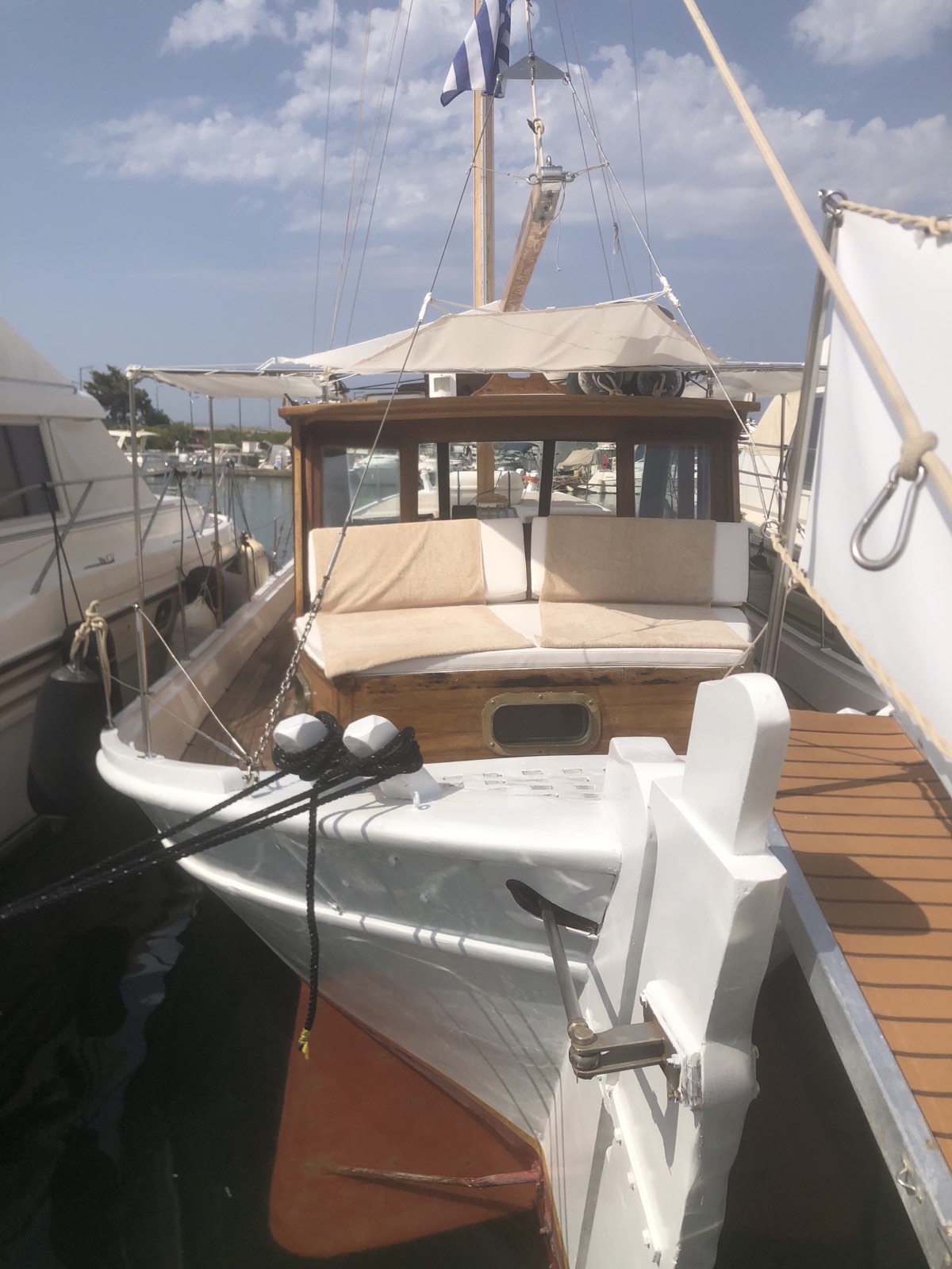 ATHINA moored bow-on, Greek flag flying above the wooden cabin
